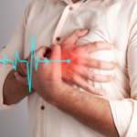 A man in a shirt having chest pain holding his chest